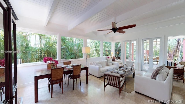 sunroom / solarium featuring beamed ceiling, french doors, a wealth of natural light, and ceiling fan