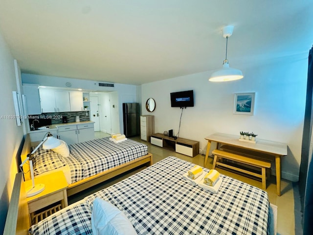 bedroom featuring black refrigerator