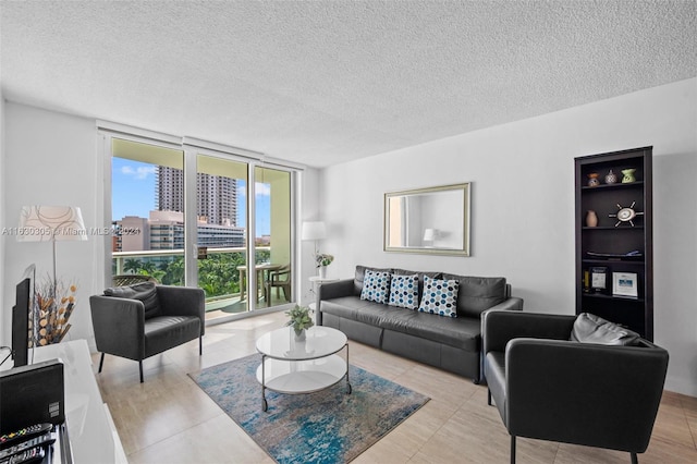 living room featuring light tile patterned flooring, expansive windows, and a textured ceiling