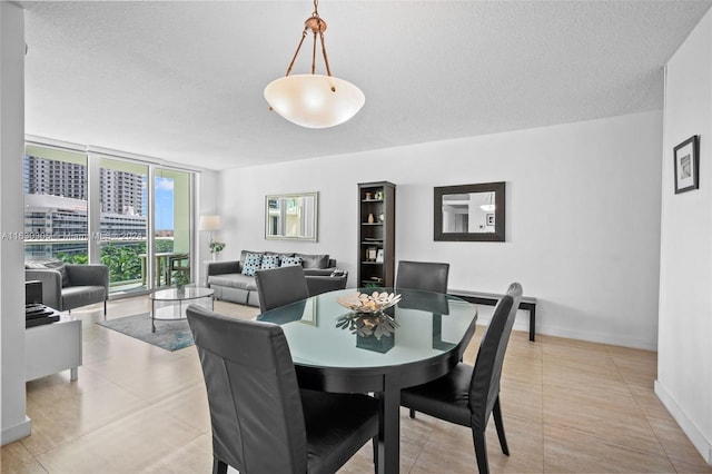 dining room with a textured ceiling, light tile patterned floors, and floor to ceiling windows