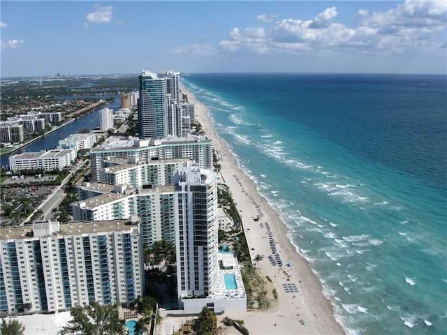 drone / aerial view featuring a water view and a beach view