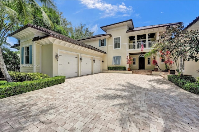 view of front of house featuring a garage and a balcony