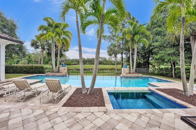 view of swimming pool with an in ground hot tub and a patio