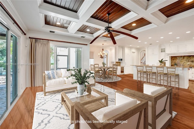 living room with beamed ceiling, ornamental molding, and coffered ceiling