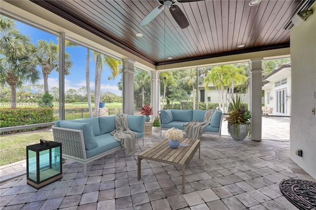 sunroom / solarium with wood ceiling and ceiling fan