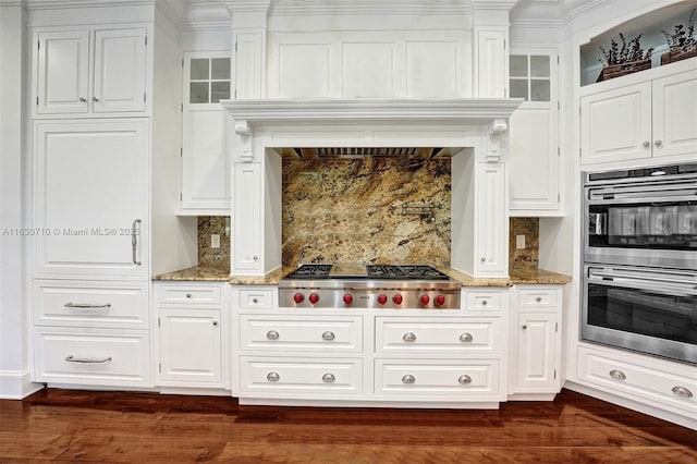 kitchen featuring stainless steel appliances, light stone countertops, and white cabinets