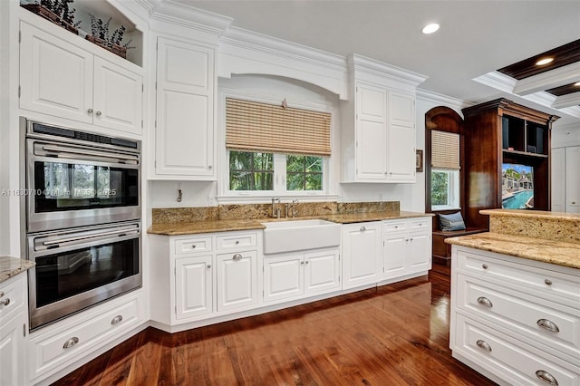 kitchen featuring crown molding, sink, double oven, and white cabinets