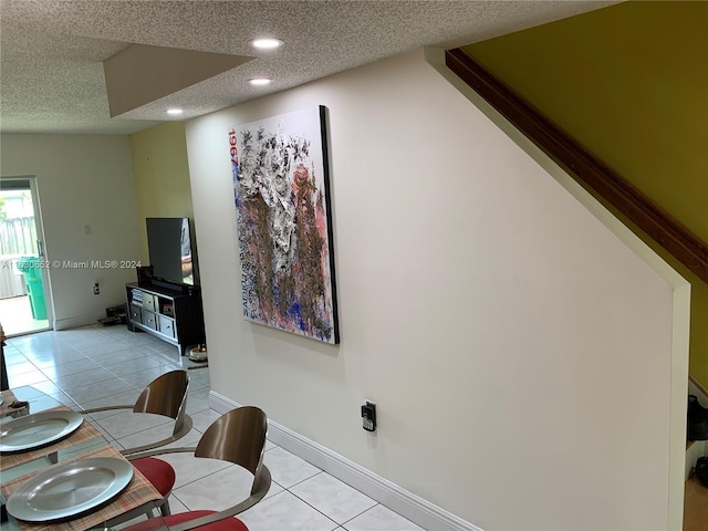 dining room featuring light tile patterned floors and a textured ceiling