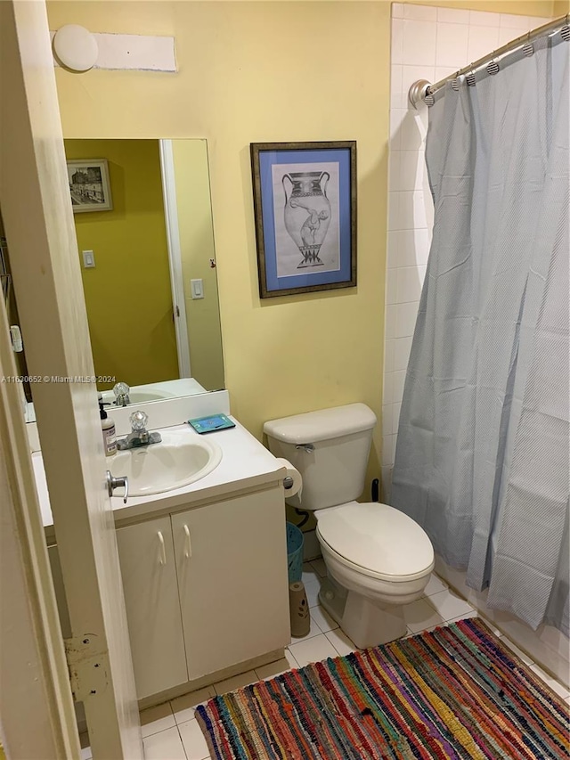 full bathroom with tile patterned floors, shower / tub combo with curtain, vanity, and toilet