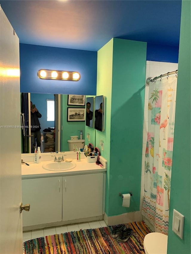 bathroom with tile patterned flooring, vanity, toilet, and a shower with shower curtain