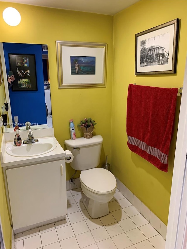 bathroom with tile patterned floors, vanity, and toilet