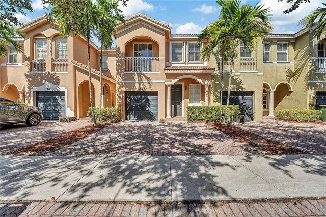 mediterranean / spanish-style house featuring a balcony and a garage