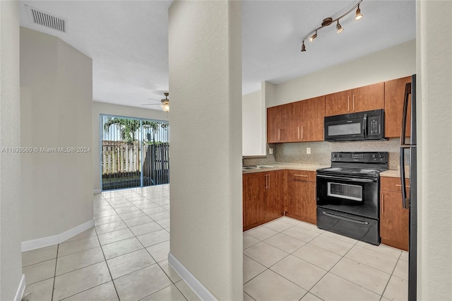 kitchen with tasteful backsplash, rail lighting, light tile patterned floors, ceiling fan, and black appliances