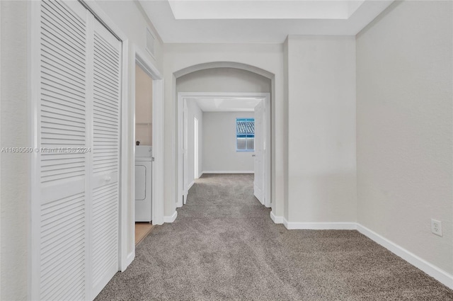 hallway featuring washer / dryer and carpet flooring