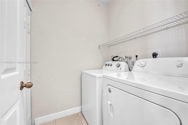 washroom with separate washer and dryer and light tile patterned floors