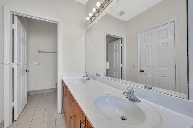 bathroom featuring tile patterned flooring and dual bowl vanity