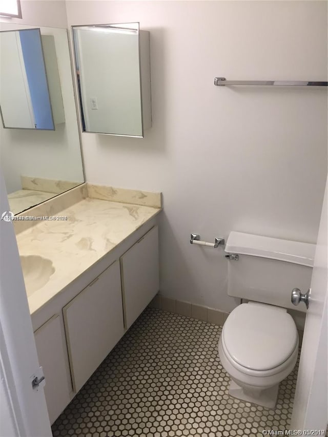 bathroom featuring vanity, toilet, and tile patterned floors