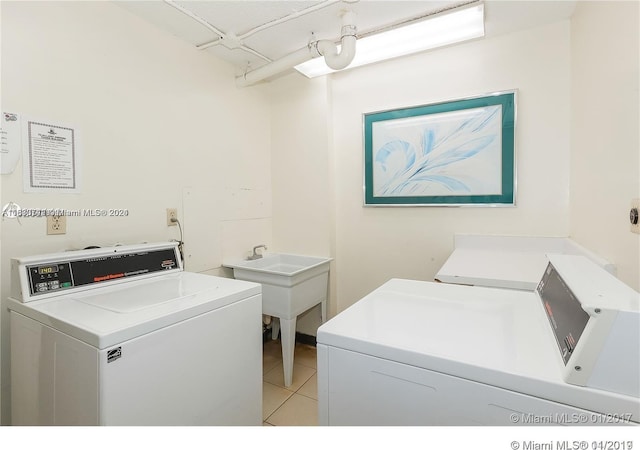 washroom featuring independent washer and dryer and light tile patterned floors