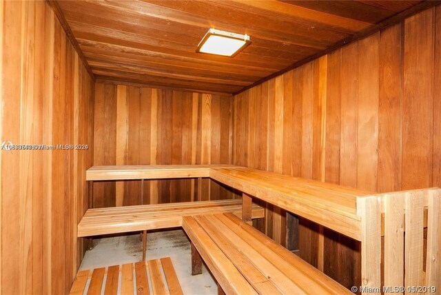 view of sauna featuring wooden walls and wood ceiling