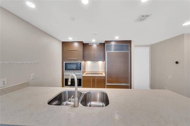 kitchen with sink and built in appliances