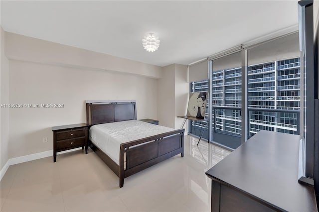 bedroom with light tile patterned floors and floor to ceiling windows