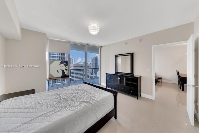 bedroom with light tile patterned floors, access to exterior, and a wall of windows