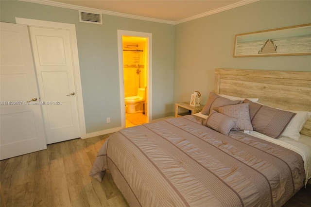 bedroom featuring ensuite bath, crown molding, and light hardwood / wood-style floors