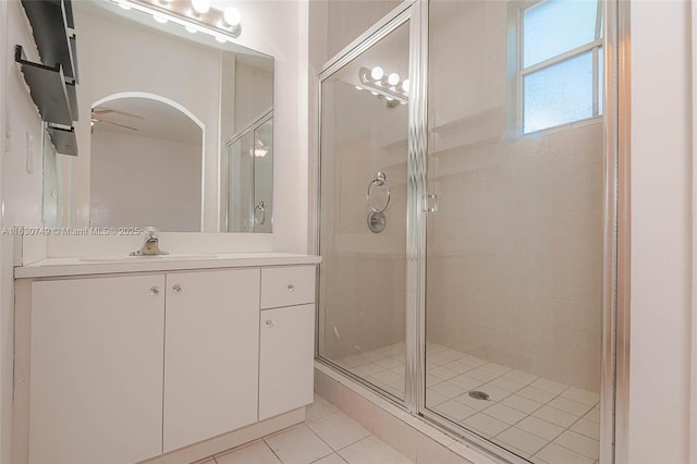 bathroom with a stall shower, vanity, and tile patterned floors