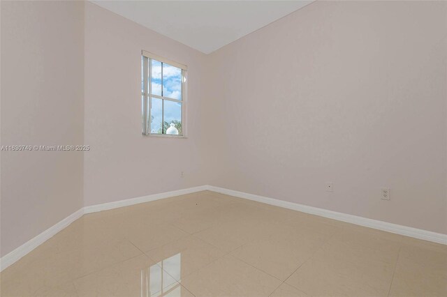 empty room with tile patterned flooring