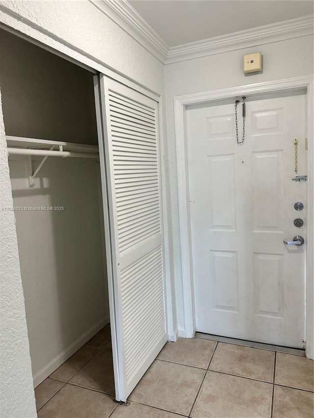 doorway to outside featuring light tile patterned flooring