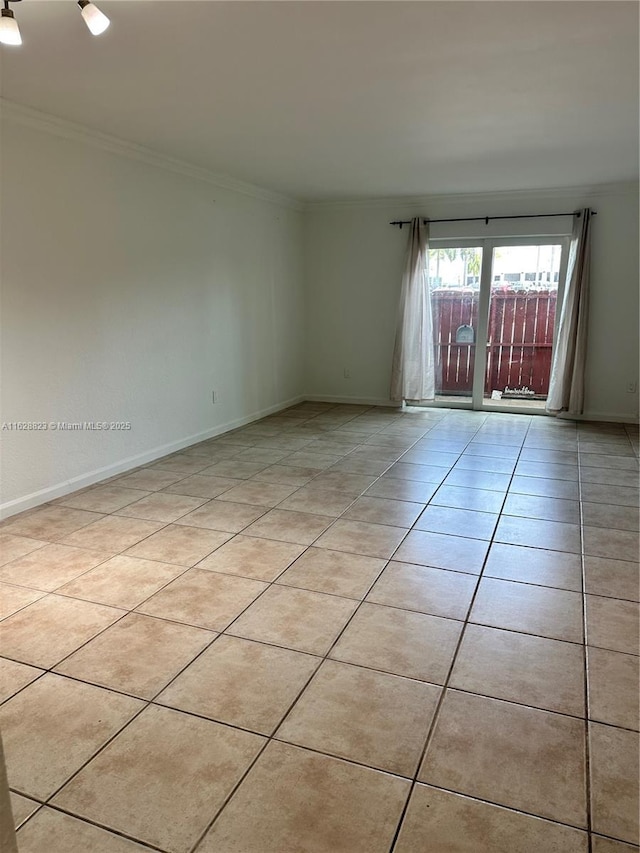 unfurnished room with light tile patterned flooring and crown molding