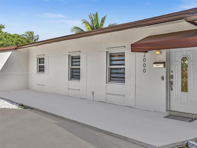 entrance to property with a patio area