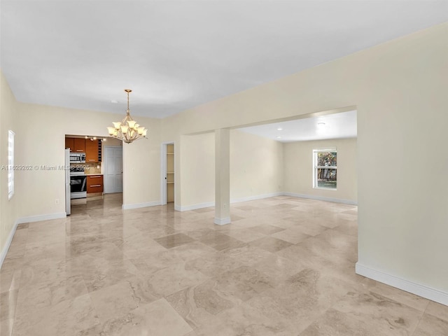 unfurnished room featuring a notable chandelier