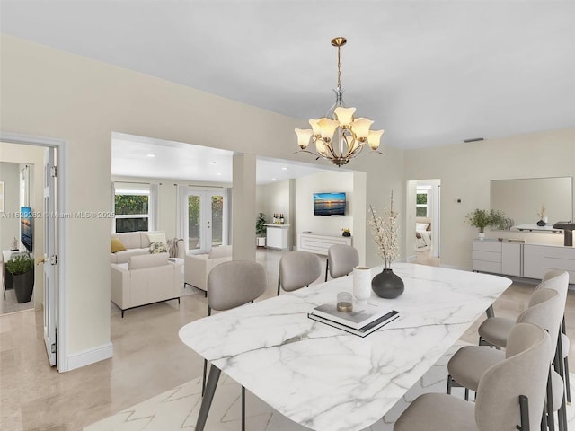 dining space featuring an inviting chandelier and french doors