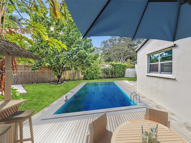 view of swimming pool with a lawn and a patio