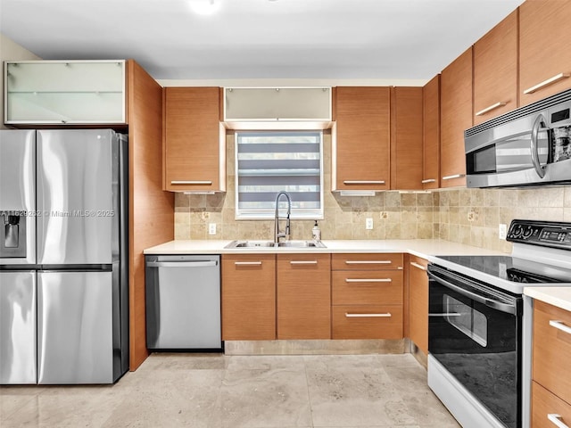 kitchen featuring appliances with stainless steel finishes, tasteful backsplash, and sink