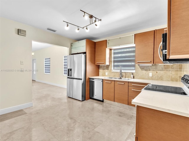 kitchen featuring decorative backsplash, sink, and stainless steel appliances