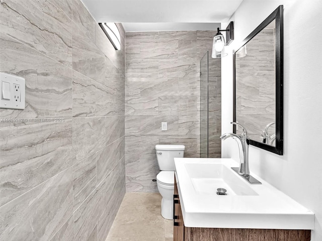 bathroom featuring tile walls, toilet, and vanity