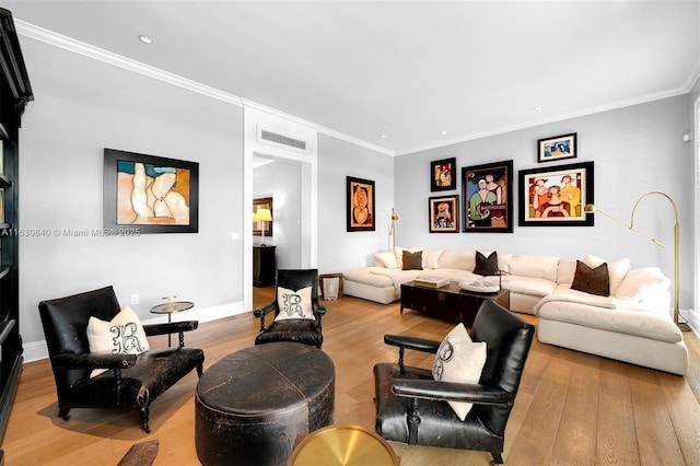 living room with light wood-type flooring and ornamental molding