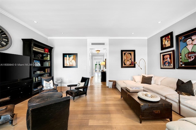 living room featuring ornamental molding and light hardwood / wood-style flooring