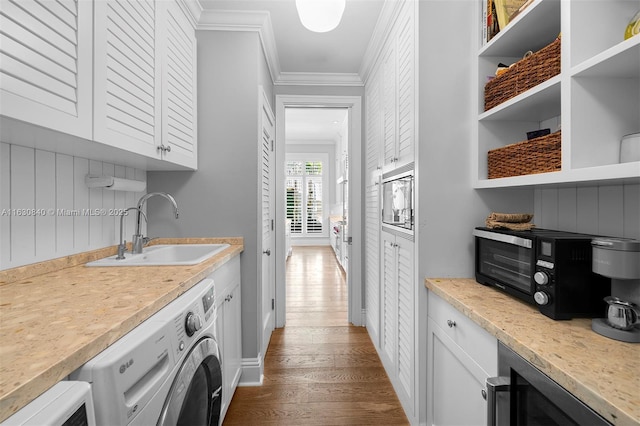 laundry area with cabinets, crown molding, sink, washer / clothes dryer, and wine cooler