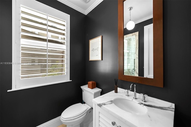 bathroom with vanity, toilet, and ornamental molding