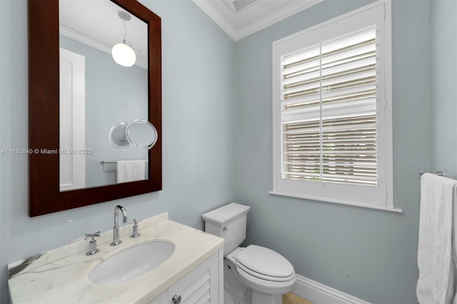 bathroom with plenty of natural light, toilet, crown molding, and vanity