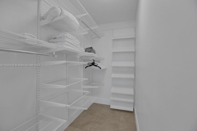 spacious closet featuring light tile patterned floors