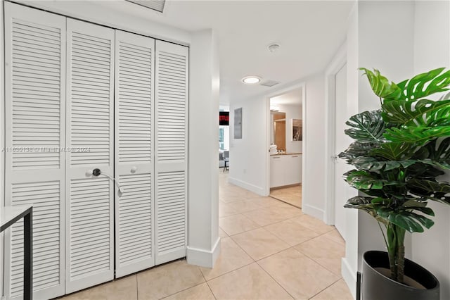 corridor with light tile patterned floors