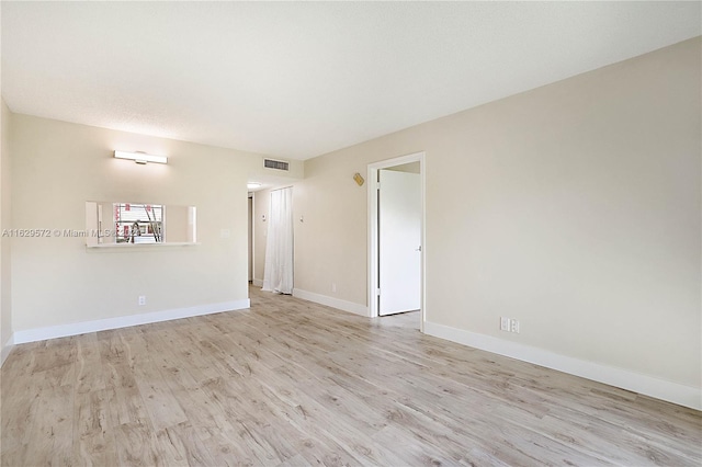 spare room with light hardwood / wood-style floors