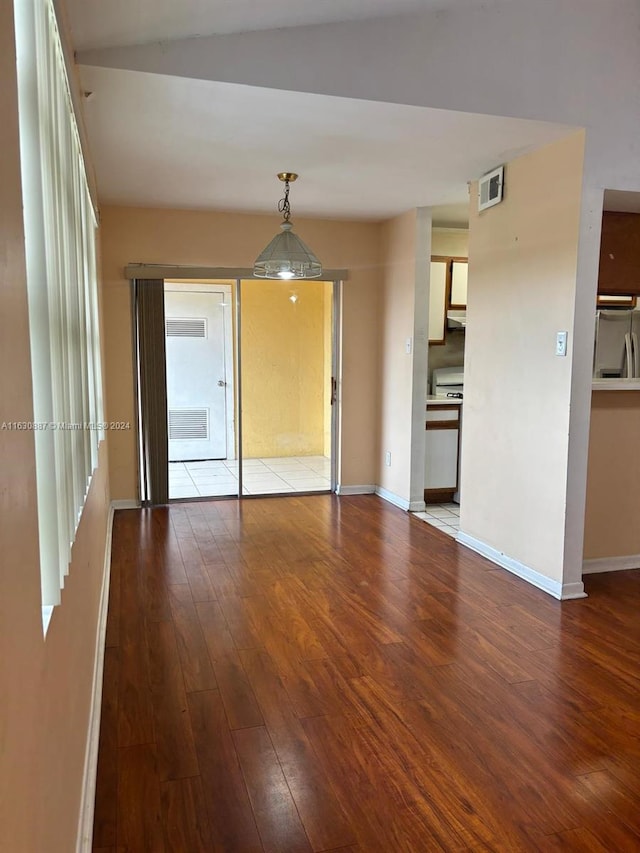 empty room with hardwood / wood-style floors