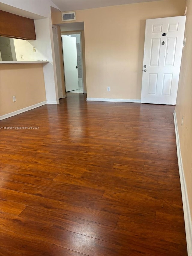 unfurnished living room with dark hardwood / wood-style flooring