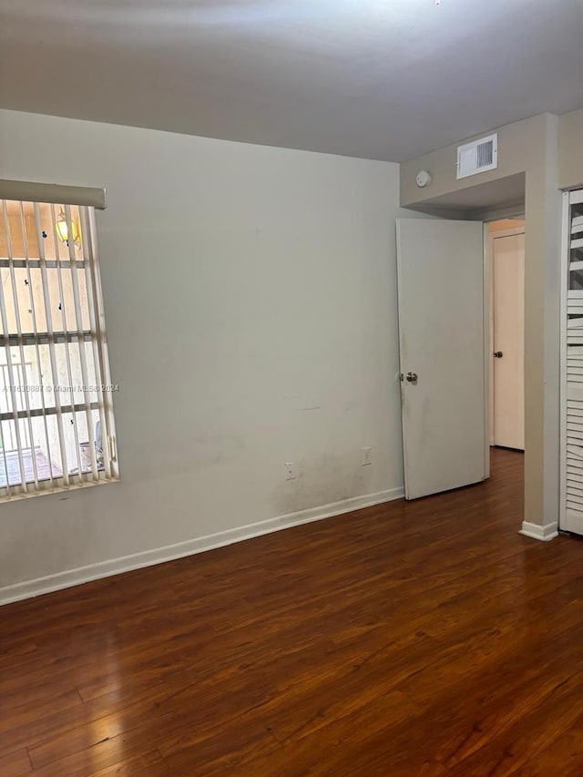 spare room featuring dark hardwood / wood-style floors