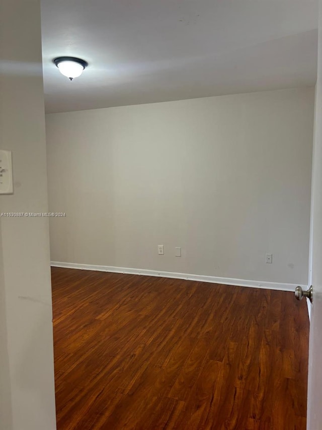 empty room with dark hardwood / wood-style floors